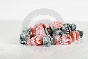 A group of pink and black jelly sweets