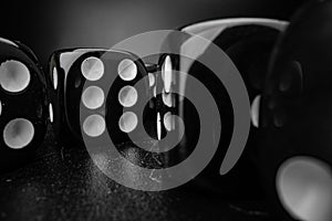 Group of playing dice cubes on black surface, macro