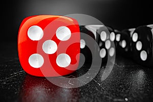 Group of playing dice cubes on black surface, macro