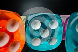 Group of playing dice cubes on black surface, macro