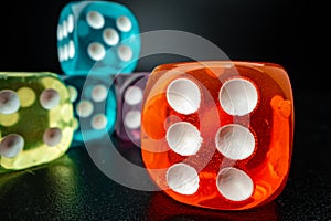 Group of playing dice cubes on black surface, macro