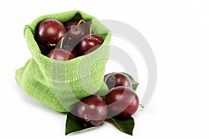 Group of plums with leaf isolated on a white.