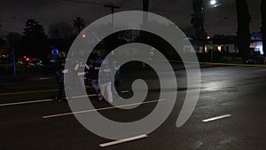 Group of Police Crossing a Street at Night During a Standoff