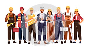 Group portrait of cute happy industry or construction workers, engineers standing together. Team of smiling male and
