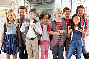 Group portrait of elementary school kids in school corridor