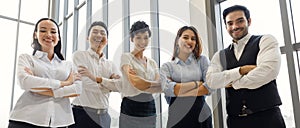 Group portrait of five diverse businessmen, two men and three women at meeting desk. They hold and cath other`s hands. Idea for