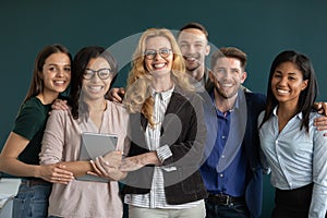 Group portrait of happy ambitious motivated multiethnic team standing together