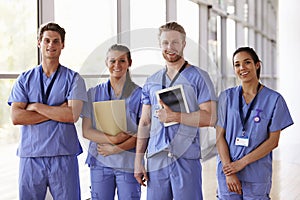 Group portrait of healthcare workers in hospital corridor