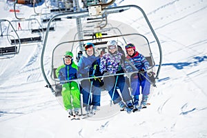 Group portrait of kids on ski resort chairlift