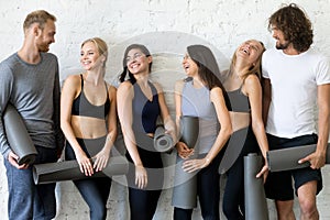 Group portrait of laughing sporty people yoga lesson