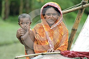 Group portrait, mother and child, boat nomads