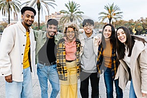 Group portrait of multi-ethnic young best friends smiling at camera in Barcelona