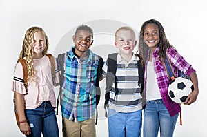 Group portrait of pre-adolescent school kids smiling on a white background