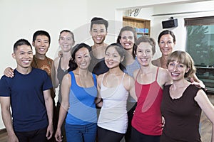 Group portrait of smiling group of people in a yoga studio