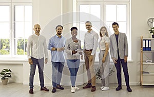 Group portrait of team of joyful successful and intelligent multiracial business colleagues.