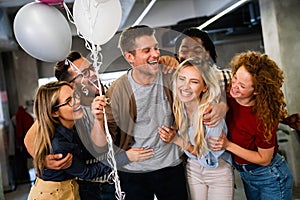 Group portrait of young startup business team celebrating success in the office