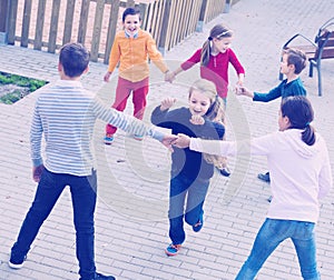 Group of positive children playing red rover