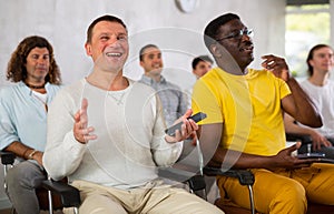 Group of positive men listening to a lecture