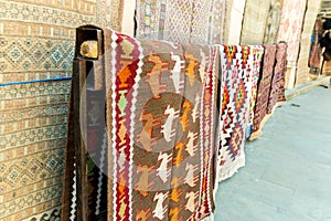 Group of precious ancient colored wool Azeri ancient carpets made by hand in ancient city at Carpet store.