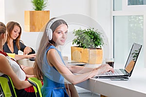 Group of pretty businesswoman working together with new startup project using laptop computer in modern loft. People and