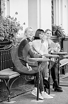 Group pretty women terrace entertain themselves with reading and listening. Coffee cafe. Way to relax and recharge