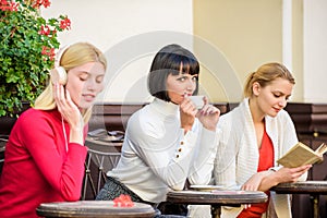 Group pretty women terrace entertain themselves with reading and listening. Way to relax and recharge. Female leisure