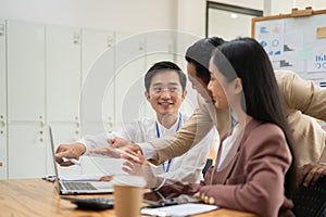 A group of professional Asian businesspeople are discussing work and planning a project