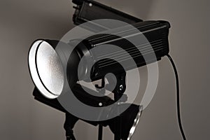 Black studio illuminators on a grey background