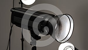 Black studio illuminators on a grey background