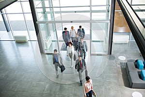 Group of professional business people walking in building