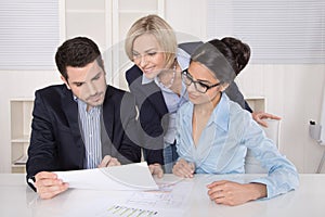 Group of a professional business team sitting at the table talking together.