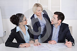 Group of a professional business team sitting at the table talking together.