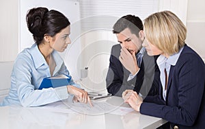 Group of a professional business team sitting at the table talking together.