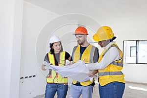 Group of professional construction workers engineers team meeting standing together work in new house construction site with floor