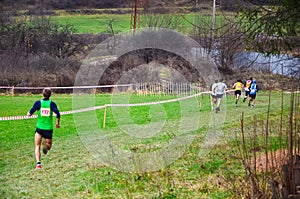 Group of professional cross country athletes running in competition in autumn nature. Sport or orienteering run concept