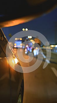 Group of professional cyclists training on highway with safety escort car, security light