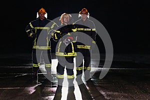 A group of professional firefighters marching through night on a rescue mission, their determined strides and fearless