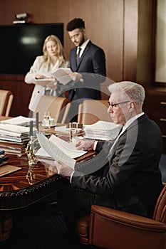 Group of Professional Lawyers Doing Paperworks in Conference Room