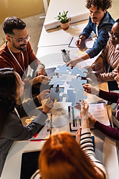 Group of professional people playing puzzle in the office