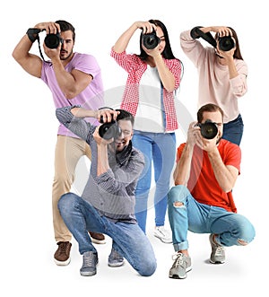 Group of professional photographers with cameras on white background