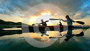 Group of professional rowers are sailing in the sunlight