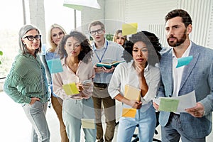 Group of professionals collaborating in an office setting with creative tools and teamwork
