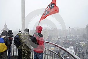 Group of protesters looking from the observation deck at the tent town set on Majdan Nezalezhnosti square, far-rightists
