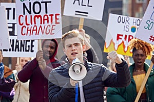 Group Of Protestors With Placards And Megaphone On Demonstration March Against Climate Chane photo