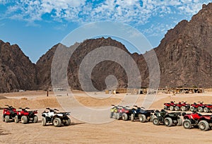 A group of quad bike parked in the Sinai desert against the backdrop of mountains
