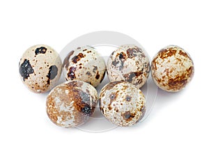 Group of quail eggs over white background