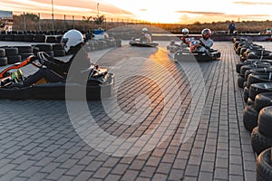 A group of racers on karts are approaching the finish line in an active battle for first place in the championship, sreet, rent.