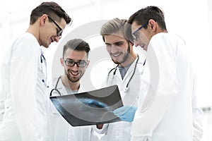 Group of radiologists discussing x-ray
