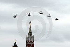 A group of reconnaissance and attack helicopters Ka-52 Alligator Hokum B fly in the sky over Red Square during an air parade ded