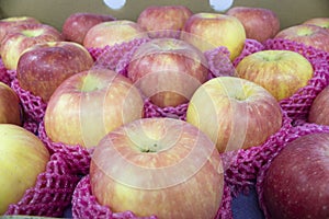 Group of red apples arranged in a box